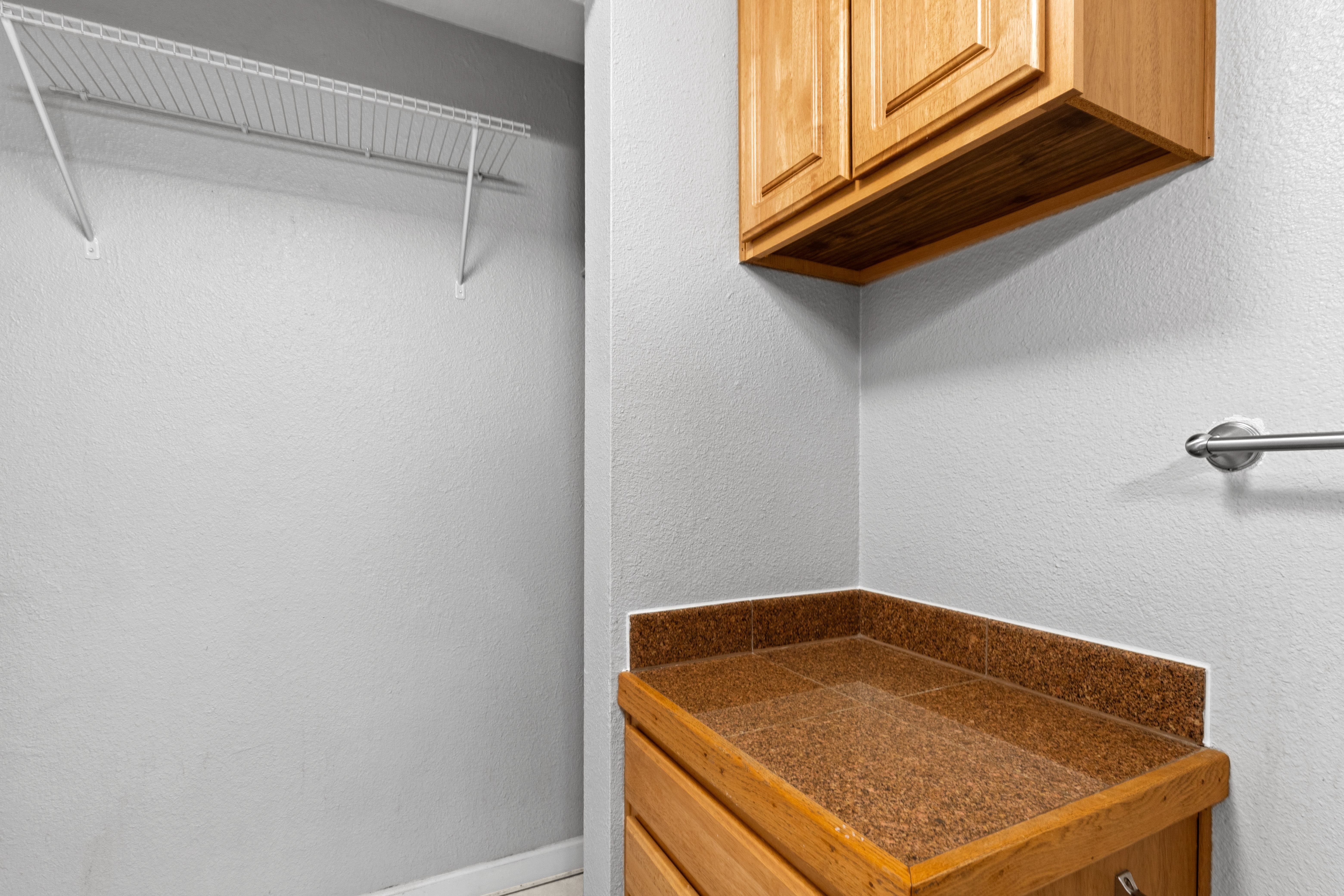 the closet in a bathroom with a sink and a shower